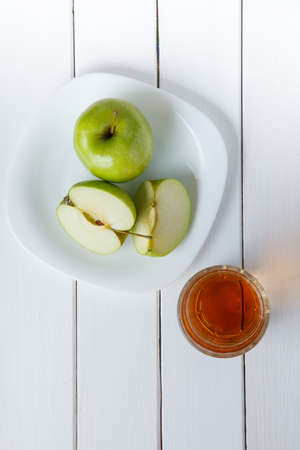 Apple juice from green apples on a white wooden backgrounddの写真素材