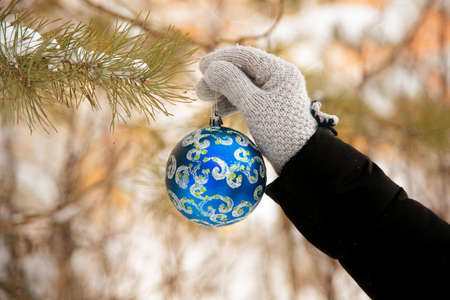 Christmas concept with hand and blue ball - christmas tree toy.christmas ball in female handの写真素材