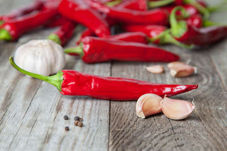 The composition of red hot peppers with spices on a wooden tableの写真素材