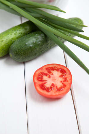 Vegetable composition - tomato, cucumber and green onion on white wooden backgroundの写真素材