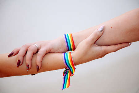 Cropped shot of young women LGBT lesbian couple holding hands with LGBT pride.の写真素材