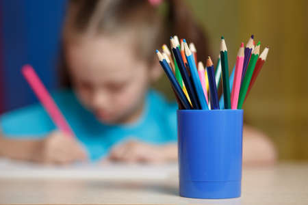 education and school concept - little girl with an open bookの写真素材