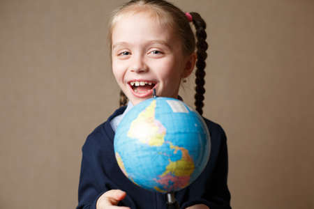 The little girl with the globe is laughingの写真素材