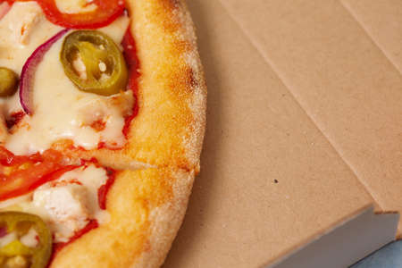 Pizza in cardboard delivery box. Fast food concept. Food background texture. copy spaceの写真素材