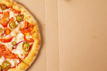 Pizza in cardboard delivery box. Fast food concept. Food background texture. copy spaceの写真素材