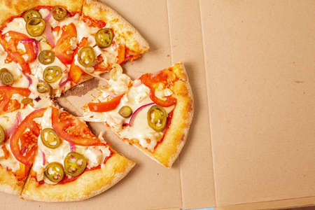 Pizza in a cardboard box against. Space for text. View from above. Pizza delivery. Pizza menu.の写真素材
