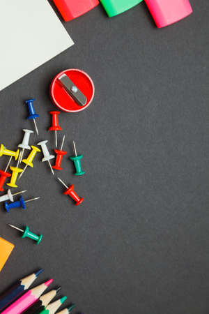 School supplies on dark background. top view