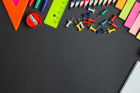 back to school.supplies on dark background. top view
