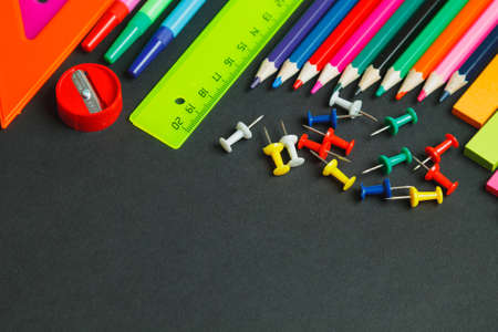 Education background. School stationery on blackboard. top view