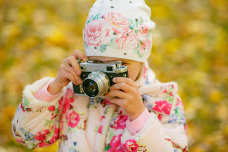 child photographer holding a camera at the parkの写真素材