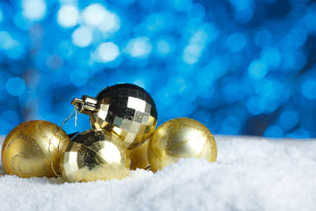 Golden Christmas Decoration Bunch of Ornate Bauble. Glittering Ball Close up. Traditional Wintertime Holiday Attribute on Snow Sparkling Bokeh Background. New Year Celebration Symbolの写真素材