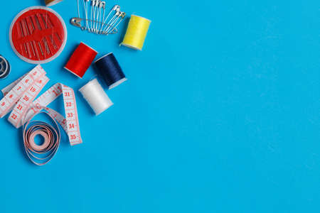 Colorful Thread Spools Tailor Equipment Copy Space. Fibers Set with Pins Craftsman Items Sewing Tools Empty Background. Fashion Designer Accessory Clothes Manufacture Seamstress Supplies Compositionの写真素材