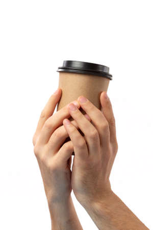 Man hand holding brown paper cup of coffee with black lid isolated on white backgroundの写真素材