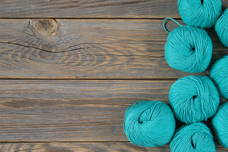 Balls of bright woolen yarn on old wood background. With Copy Space.の写真素材