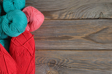 Colorful yarn balls on a wooden background room for copy space.