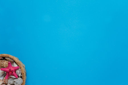 Nice Seashell Collection Wood Basket Copy Space. Colorful Tropical Starfish Decorative Composition Pile Marine Conch Azure Background. Summer Voyage Concept Ocean Fauna Flat Lay Top Viewの写真素材