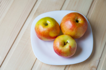 Apples on white plateの写真素材