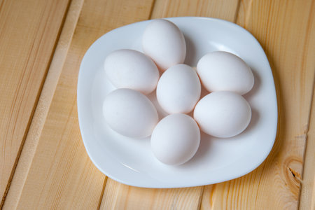 Fresh farm eggs on a wooden rustic background