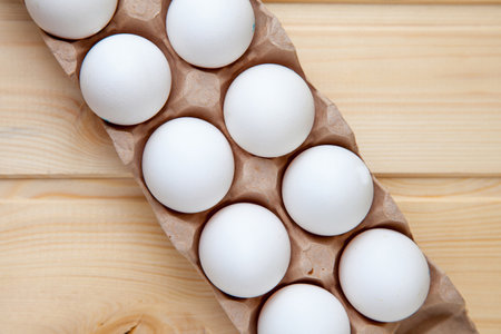 Fresh farm eggs on a wooden rustic background