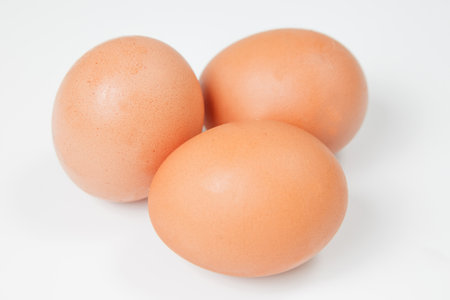 Close up.Three chicken eggs on a whiteの写真素材