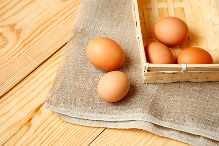 Close up of fresh chicken egg on nature wooden table