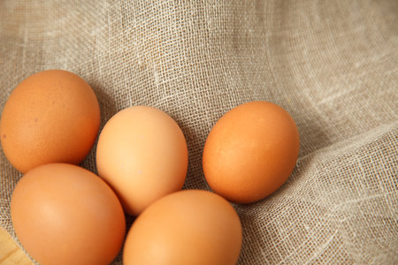Chicken eggs on burlap vintage background, photo top viewの写真素材