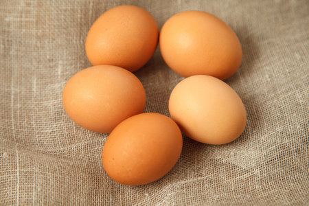 Chicken eggs on burlap vintage background, photo top viewの写真素材