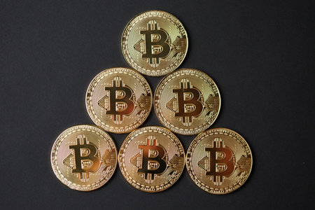 Bitcoin gold coins on dark background. Cryptocurrency conceptの写真素材