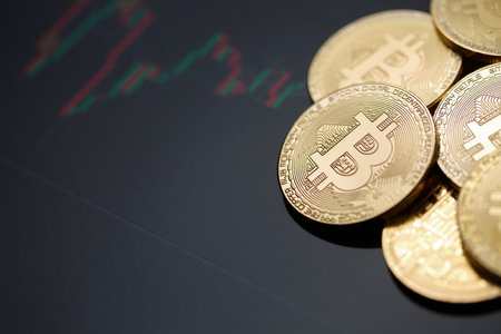 Bitcoin gold coin and chart background. Virtual cryptocurrency concept.