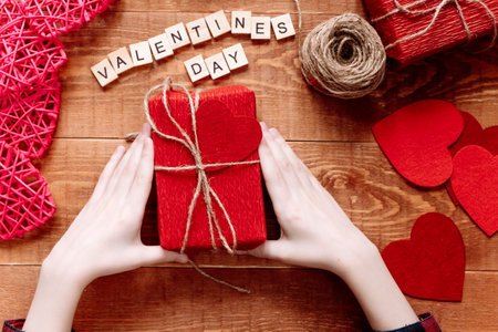 Valentine's Day background. Valentine gift making, diy hobby. Children's DIY concept. Making heart decoration or greeting card. Handmade concept.の写真素材