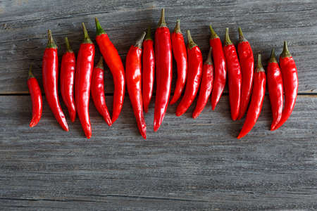 red chili peppers on wooden boardの写真素材