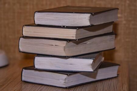 stack of old books on the table side view.の写真素材