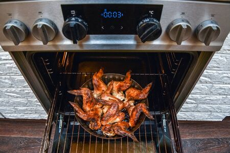baked chicken wings in the oven at home during quarantine isolation.の写真素材