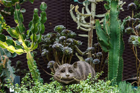 Singapore - 10 January 2018: growing plants and cactus with ceramic cat figure in a botanical garden.のeditorial素材
