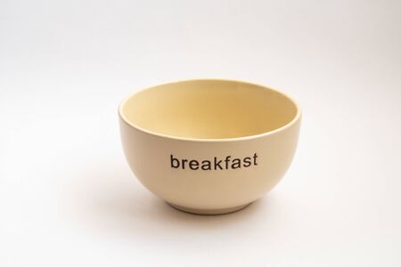 yellow plate with breakfast inscription isotated on white background.の写真素材