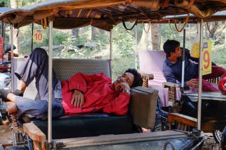 Siem Reap, Cambodia - 15 01 2019: Tuk Tuk drivers resting.のeditorial素材