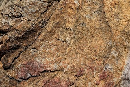 Rock texture and surface background. Cracked and weathered natural stone background.