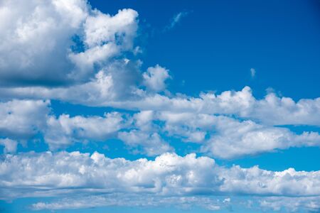White heap clouds in the blue sky. Cloudscape over horizon. Heaven.の写真素材