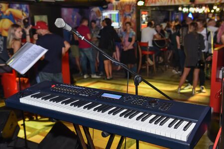 close up of microphone and keyboard on stage in a bar.