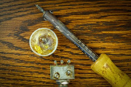 soldering iron and rosin on a wooden table to repair the device.の写真素材