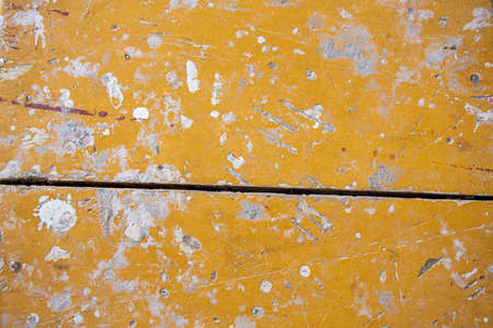 orange wooden surface stained with paint and dirty.