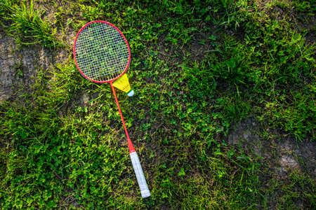 Badminton racket with a shuttlecock on the green grass, summer active games. Copy space.の写真素材