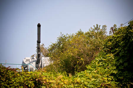 Barrel of gun mount on the background of sky and green trees.の写真素材