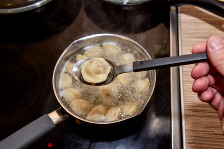 Dumplings in boiling water. Meat dumplings are boiled in a pot of boiling water.の写真素材