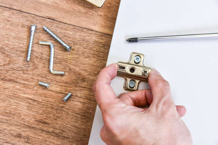 Assembly of cabinet furniture. screwdriver, screws, furniture fittings, door hinges. self-assembly of furniture.の写真素材