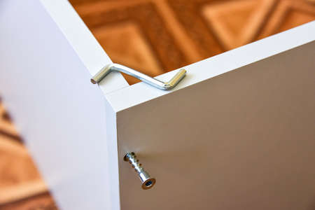 Assembly of cabinet furniture. screwdriver, screws, furniture fittings, door hinges. self-assembly...