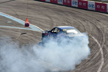 VLADIVOSTOK, RUSSIA - OCTOBER 02: Car drift, Sports car wheel drifts and a lot of smoke on the track. Russian drift show RDS without borders on October 02, 2021.のeditorial素材