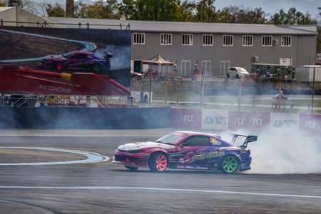 VLADIVOSTOK, RUSSIA - OCTOBER 02: Car drift, Sports car wheel drifts and a lot of smoke on the track. Russian drift show RDS without borders on October 02, 2021.のeditorial素材