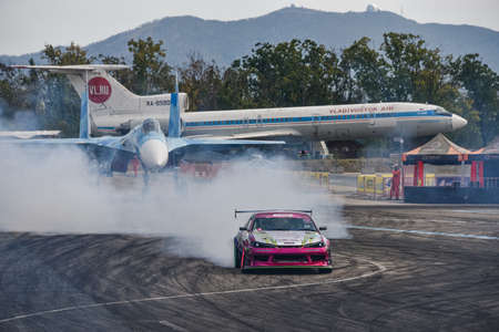 VLADIVOSTOK, RUSSIA - OCTOBER 02: Car drift, Sports car wheel drifts and a lot of smoke on the track. Russian drift show RDS without borders on October 02, 2021.のeditorial素材