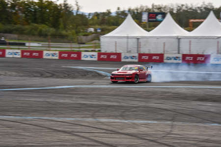 VLADIVOSTOK, RUSSIA - OCTOBER 02: Car drift, Sports car wheel drifts and a lot of smoke on the...